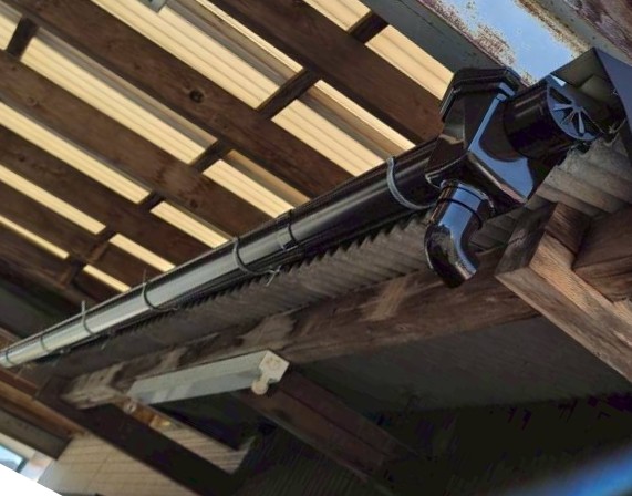 店舗雨樋の交換を行っている様子