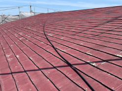 施工前の塗装が所々剥げた赤いスレート屋根